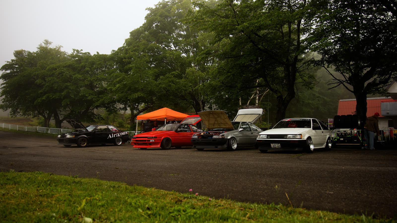 Paddock at Gunsai in morning mist with cars lined up