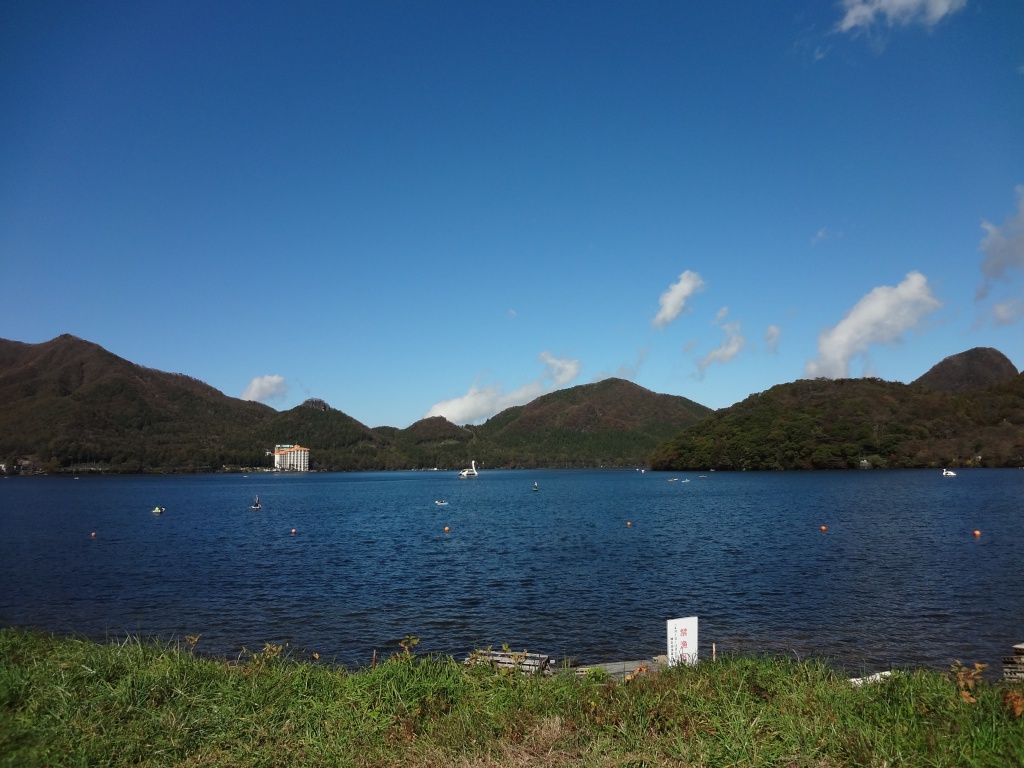 Lake Haruna with boats and forested hills behind