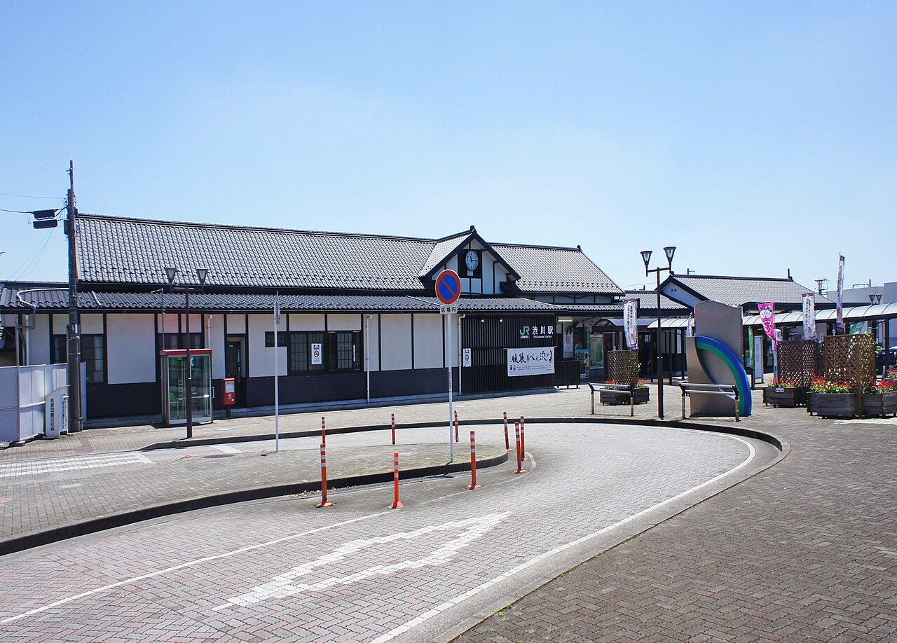 The traditional-style building of JR Shibukawa Station under a clear summer sky