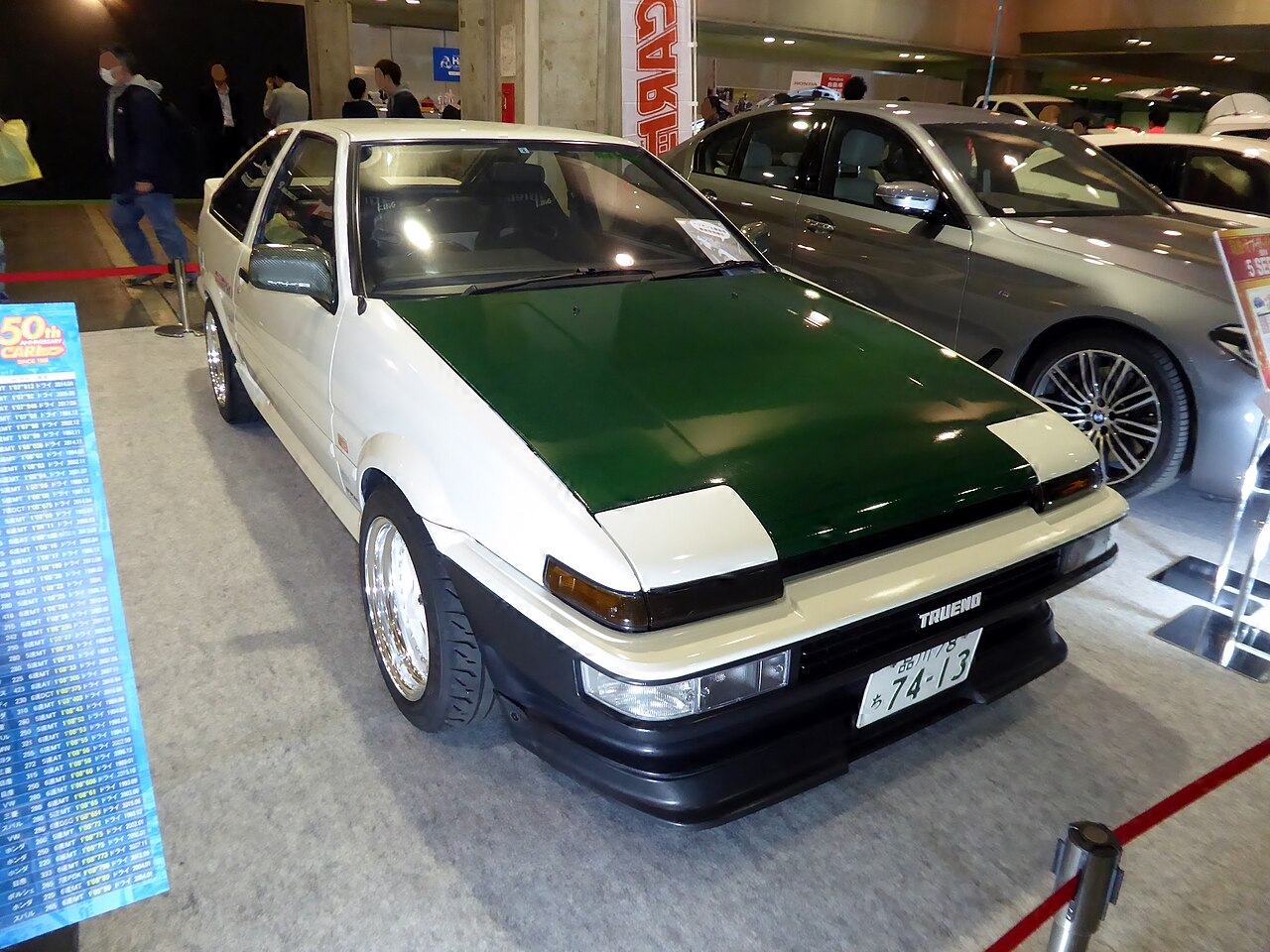 A white Sprinter Trueno AE86 with a green bonnet on show at Osaka Auto Messe 2018